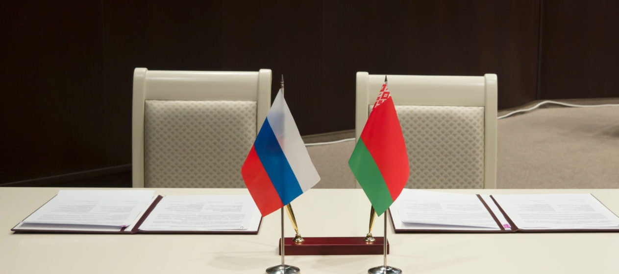 Belarus and Russia, a table for signing documents. Official documents for signatures, pens and flags of States on the table.