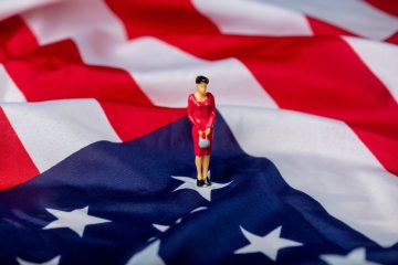 Miniature figure of a female politician on the USA flag